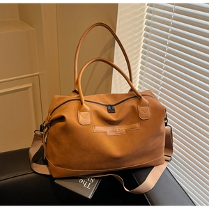 Detail view of large brown faux leather tote bag with NINGJIA logo and metal zipper