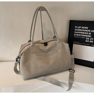 Détail du sac à main en daim gris avec logo NINGJIA et bandoulière réglable