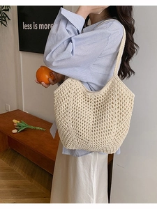 Large beige woven straw tote bag with crochet details for summer beach holidays