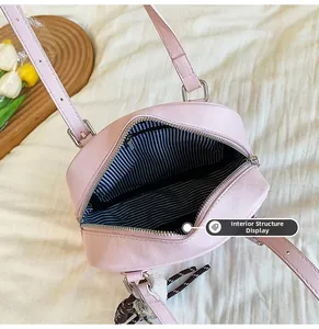 Internal structure of the pink PU leather shoulder bag showing striped lining and zipper