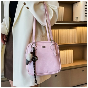 Pink PU leather shoulder bag with CON SON metal logo and ice cream charm detail