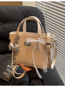 Cream bucket bag with silver hardware and lace bow decoration for women