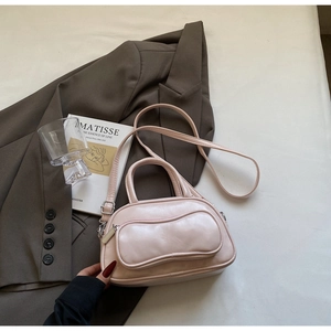 Vue de dessus d'un mini sac Boston rose clair avec fermeture éclair et garniture argentée