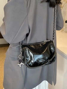 Glossy black handbag with silver chain strap and balloon dog charm for women