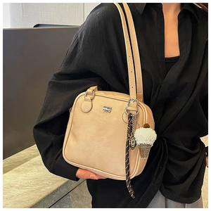 Detail of beige leather square shoulder bag with plush ice cream charm and metal logo