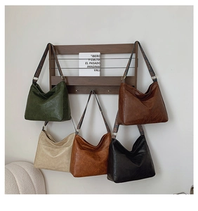 Macro view of five colorful large tote bags with retro woven straps on a wall