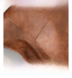 Macro detail of caramel brown leather bag with precise double-needle flat stitching