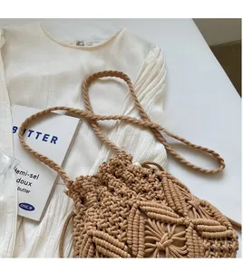 Detail of hand-woven cotton rope bucket bag featuring a drawstring closure and woven strap