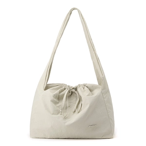 Detail of off-white waterproof nylon tote bag with drawstring closure and long strap