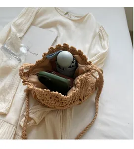 Detail shot showing the spacious interior of a woven cotton crochet shoulder bucket bag