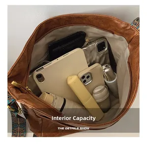 Interior view of brown leather tote showing large capacity for tablet and umbrella