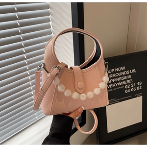 Pink leather bucket bag detail with marble bead chain and adjustable shoulder strap
