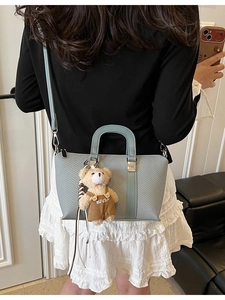 Chic blue textured crossbody bucket bag with cute teddy bear charm for women