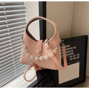 Detail of pink lychee grain crescent bag with white beaded chain and metallic buckle