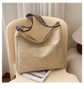 Detail view of large vintage hobo bag with ethnic style wide woven shoulder strap