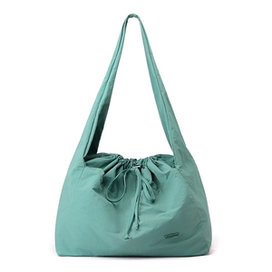 Detail view of the mint green waterproof nylon fabric texture and drawstring closure