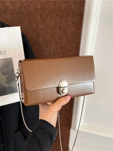 Chic brown leather crossbody box bag with silver metal chain strap and rotating lock