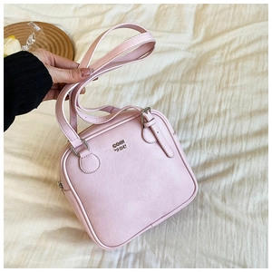 Pink PU leather square bag with adjustable strap and metallic COIN ZDN logo detail