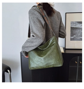 Detail of olive green vintage tote featuring ethnic embroidered wide shoulder strap
