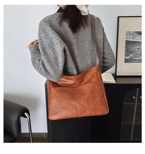 Detail of vintage brown tote bag with colorful ethnic pattern jacquard shoulder strap