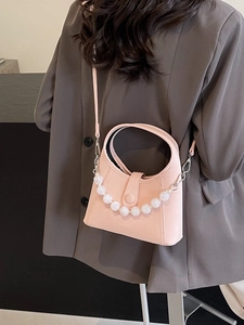 Pale pink beaded bucket bag with white faux pearls and crossbody strap for women