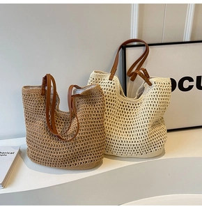 Detailed close-up of woven straw tote bags in beige and khaki with leather straps