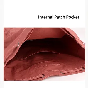 Detailed view of internal patch pocket and drawstring closure on pink backpack