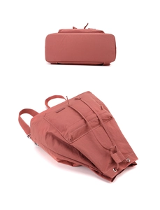 Detailed close-up of rose pink nylon backpack with drawstring closure and silver hardware
