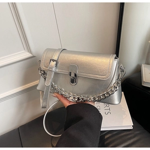 Close-up of silver textured leather bag with metallic chain and buckle detail