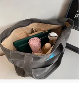 Interior view of the grey canvas tote bag showing large capacity with internal pockets