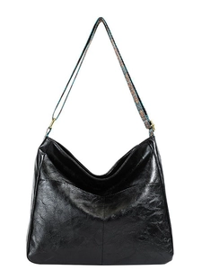 Black leather hobo bag with ethnic style colorful woven shoulder strap on white background