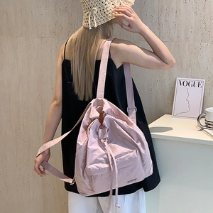 Back view of pink minimalist drawstring backpack made of lightweight nylon material