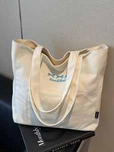 Canvas tote bag with bow embroidery and front pocket for daily casual commuting