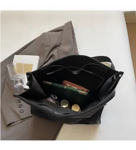 Detailed top view of large black tote bag interior with spacious pockets and zipper