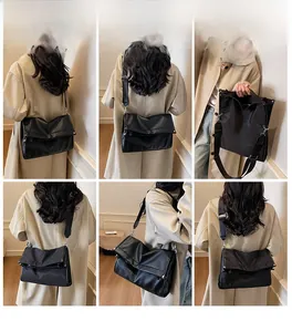 Multiple views of a black large capacity nylon shoulder bag with adjustable strap