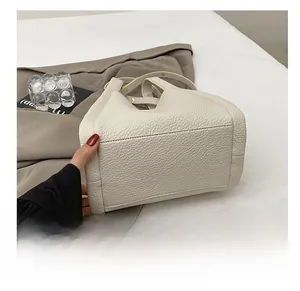 Detail of the durable base on this off-white lychee pattern leather bucket bag
