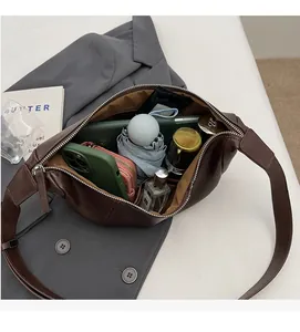 Detailed interior of deep brown dumpling bag showing space for phone and essentials