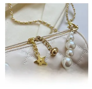Detailed close-up of quilted barrel bag with pearl chain and star-shaped golden zipper