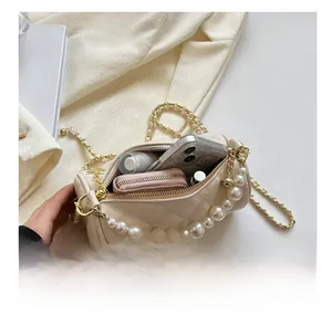 Internal view of a quilted cylinder crossbody bag showing space for phone and makeup
