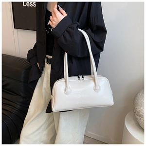 Close-up of minimalist cream white baguette bag with glossy leather and SHIYUBAG logo
