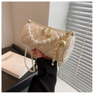 Chic quilted cream cylinder bag with pearl handle and golden star charms detail