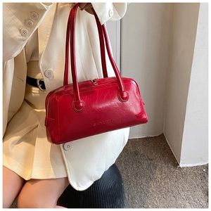 Detail of red oil-wax leather Boston bag with SHIYUBAG logo and long handles