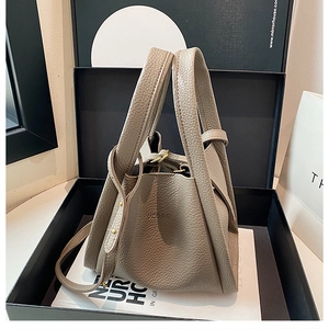 Gray pebble leather bucket bag in a gift box with shoulder strap and gold hardware
