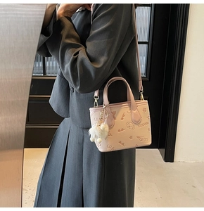 Pink PU bucket bag with cartoon embossed patterns and white plush ball charm