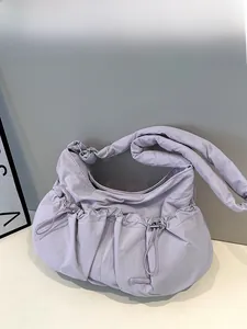 Detail of lavender puffer nylon tote bag featuring adjustable drawstring pockets