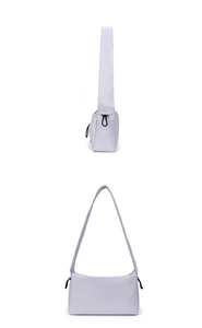 Detail view of a light purple pleated nylon shoulder bag with adjustable drawstrings