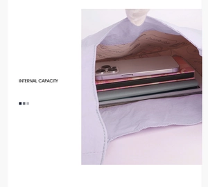 Internal view of purple nylon backpack showing large capacity for laptop and phone