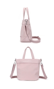 Detail of light pink nylon tote bag showing adjustable straps and silver hardware clips