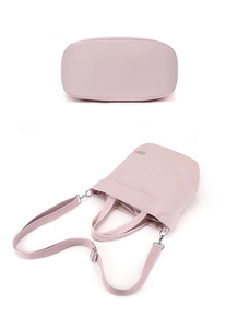 Detailed close-up of nylon tote bag bottom stitching and detachable shoulder strap