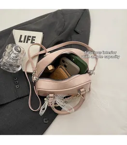 Detail view of the spacious pink bowling bag interior with silk scarf and daily items